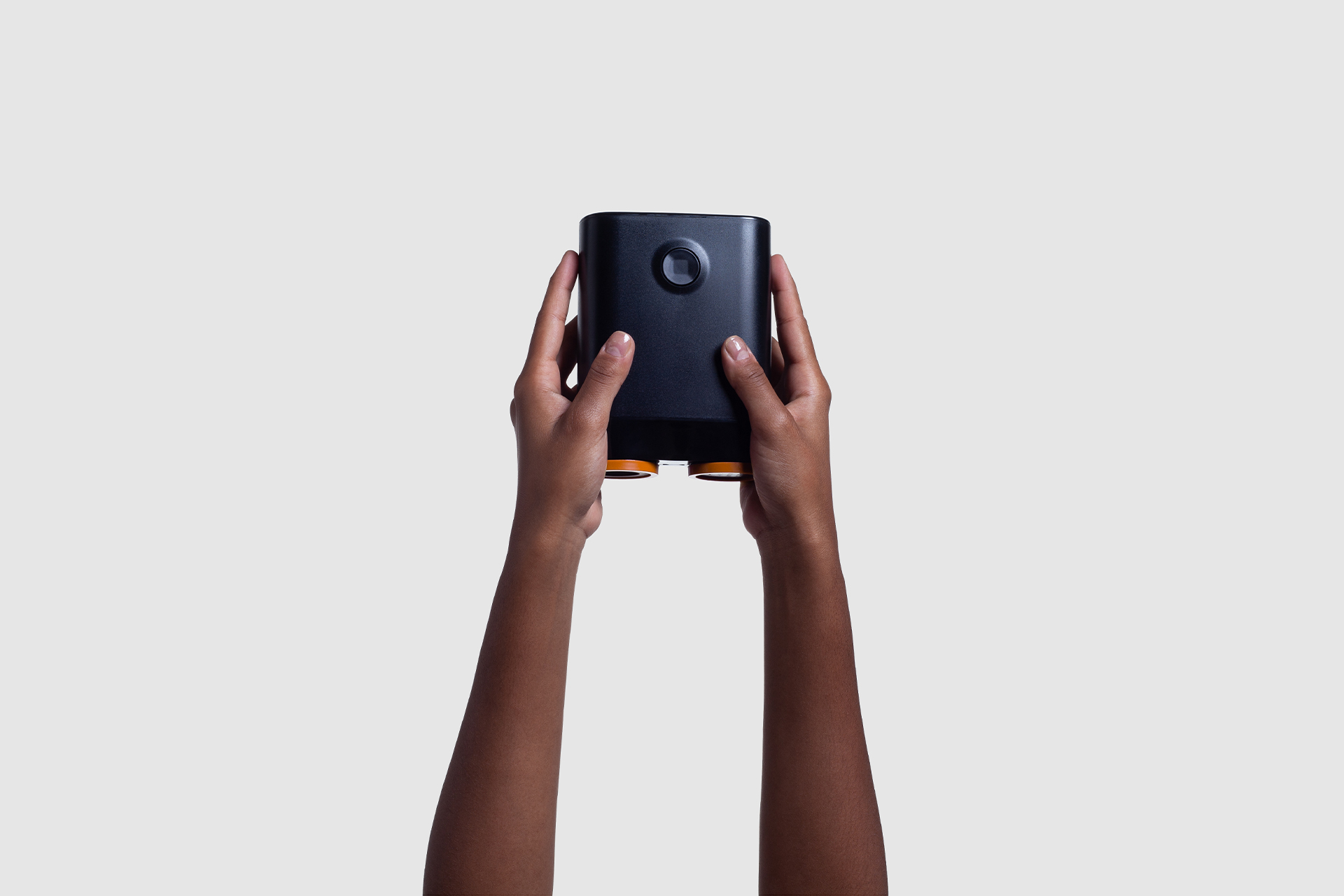 Back view of the Droid compact vacuum device held with two hands