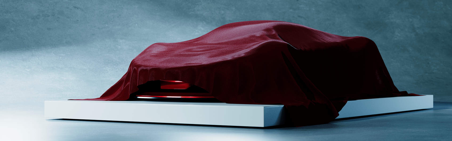 Covered Ferrari Dino 806 GT concept revealing its low silhouette beneath a red cloth