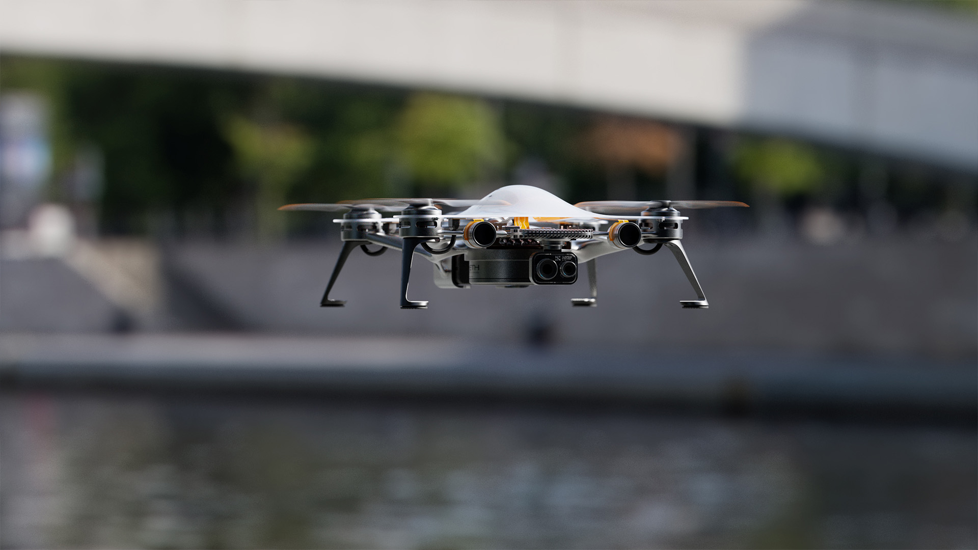 Front view of the P11 Emeth drone flying above an urban waterfront